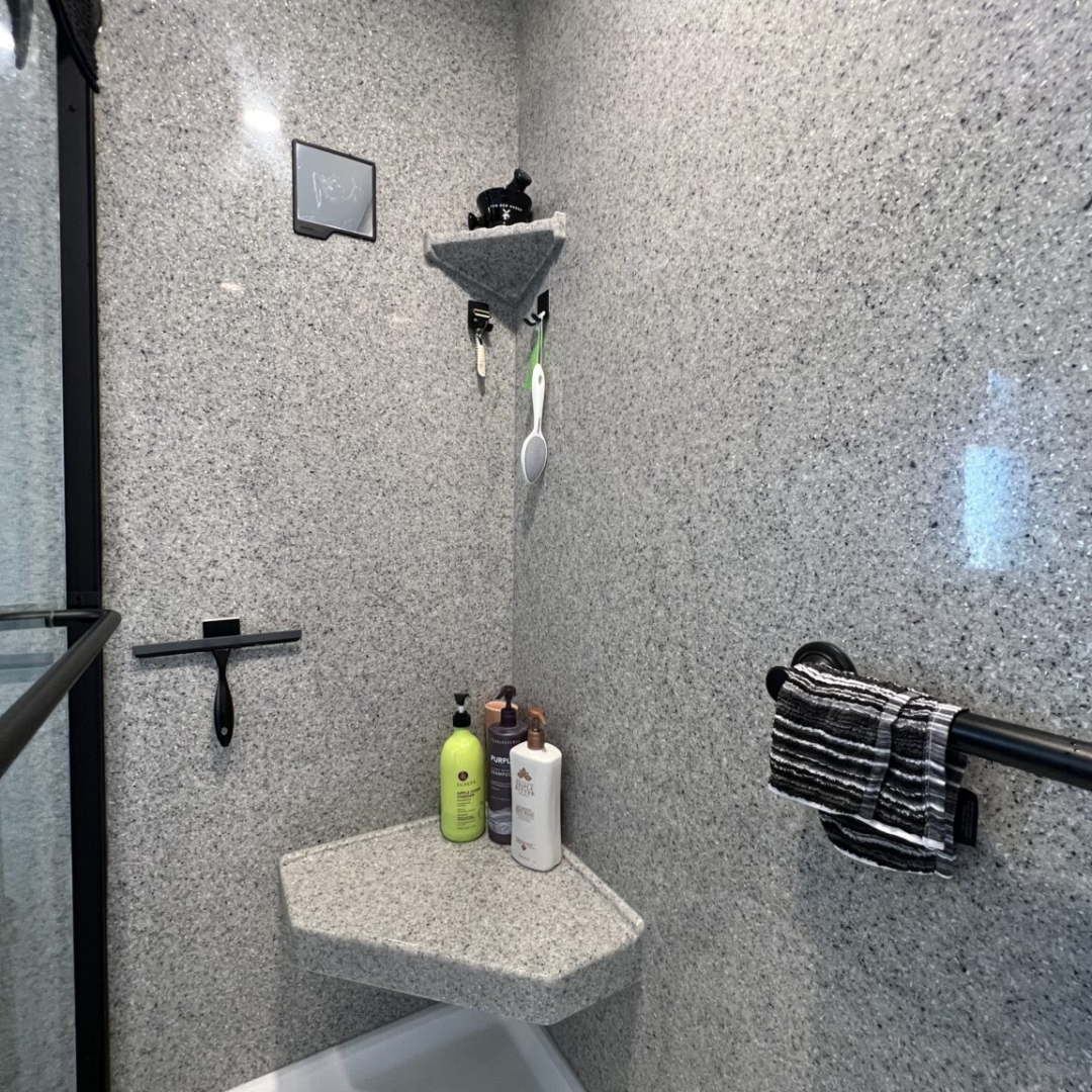 Classic black frame shower, different size shelves, grey wall