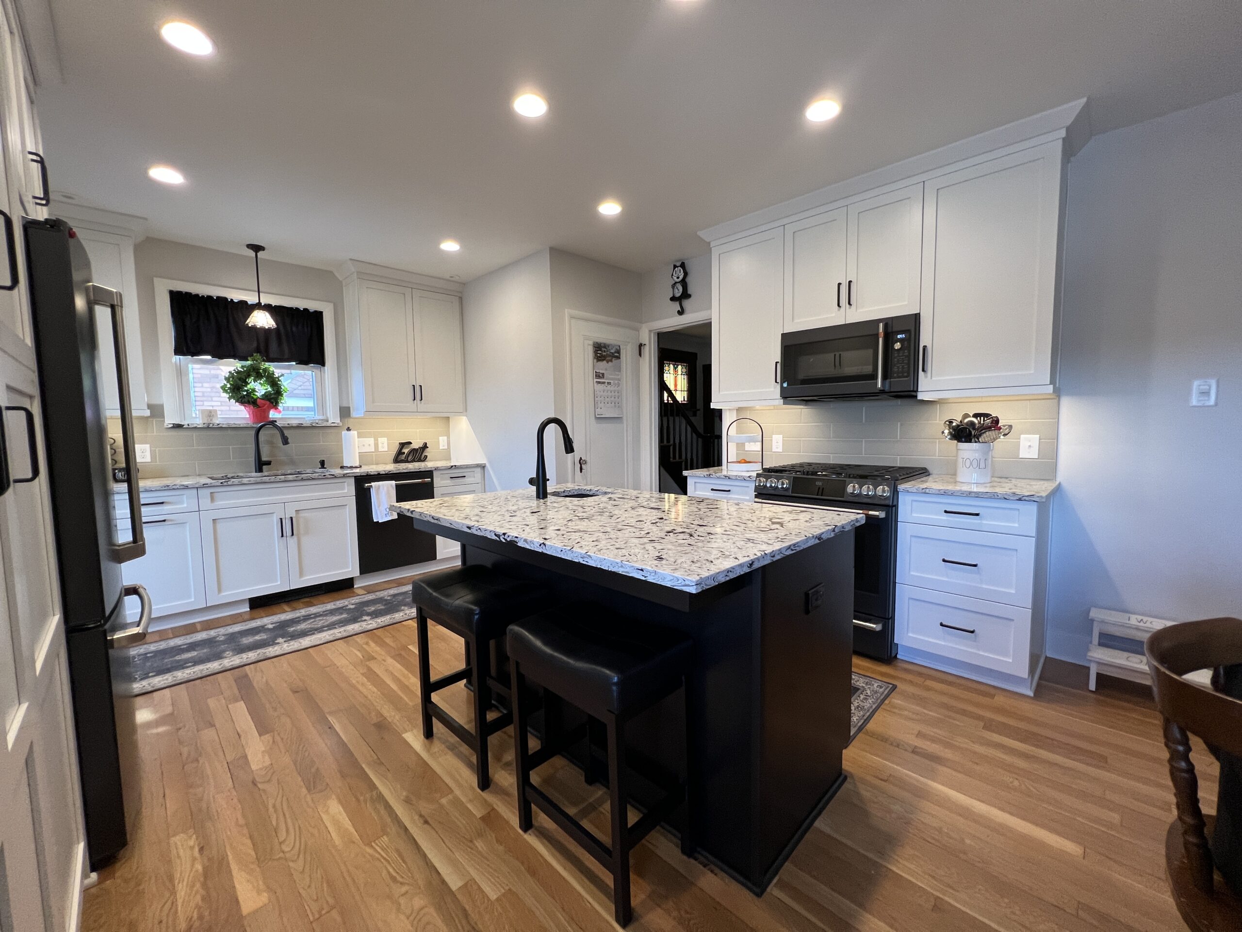 Contemporary black island kitchen remodeling, black and white marble countertop