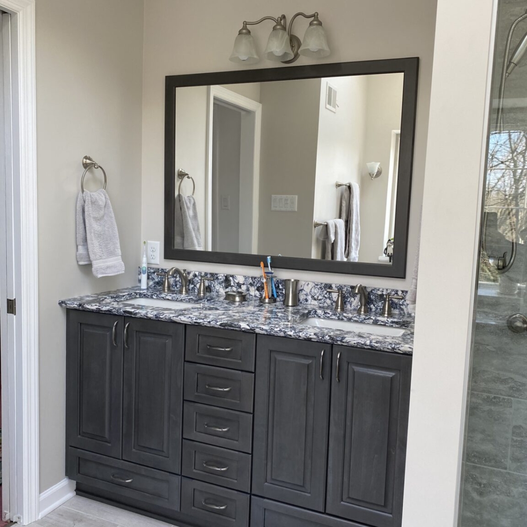 Modern bathroom, blue grey and white marble sink, dark grey cabinet space, light grey floor tiles