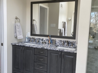 Modern bathroom, blue grey and white marble sink, dark grey cabinet space, light grey floor tiles