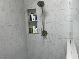 Classic bathroom remodeling, folar shower head, light colors wall shower tiles, small grey and white hexagonal floor tiles