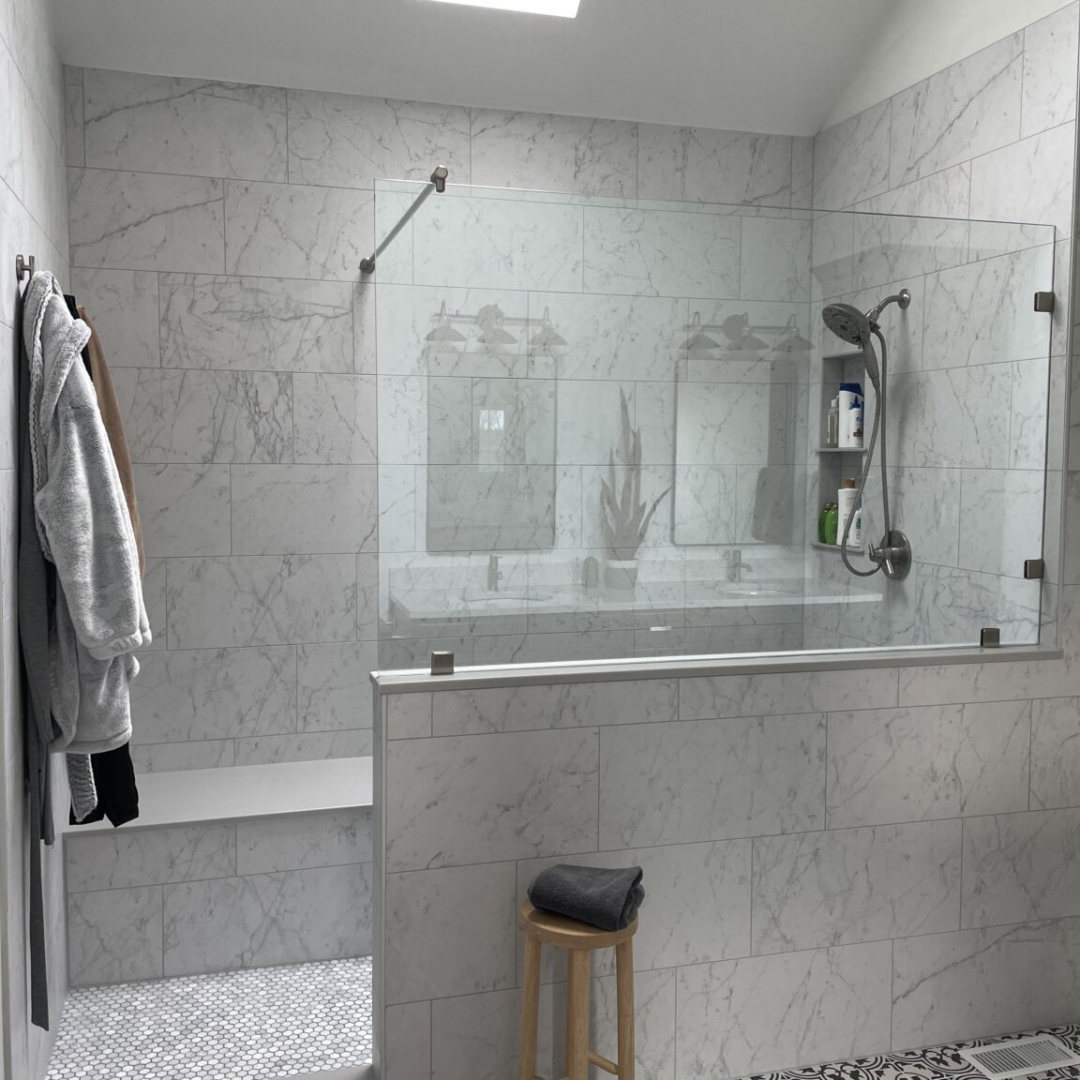 Classic bathroom remodel, folmar shower, large light colored wall tiles, shelves, traditional black and white floor tiles, toilet