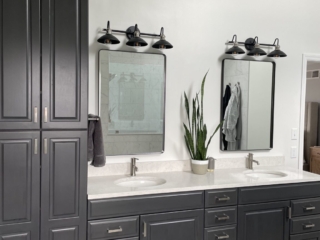 Contemporary bathroom, high linen closet, white marble countertop double sink, dark cabinet storage, traditional black and white floor tiles