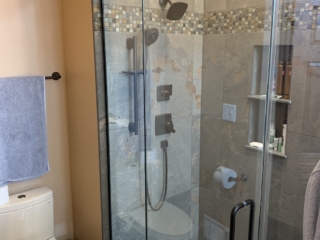 Classic bathroom, marble shower, square tile shower floor, shelves designed inside the wall
