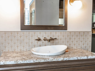 Contemporary bathroom, modern sink with modern wallpaper, vintage brown cabinet