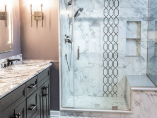 Classic bathroom, double sink with black and white marble top and dark cabinets, shower with large grey wall tiles and column of black color design, modern black and white tile floor, toilet