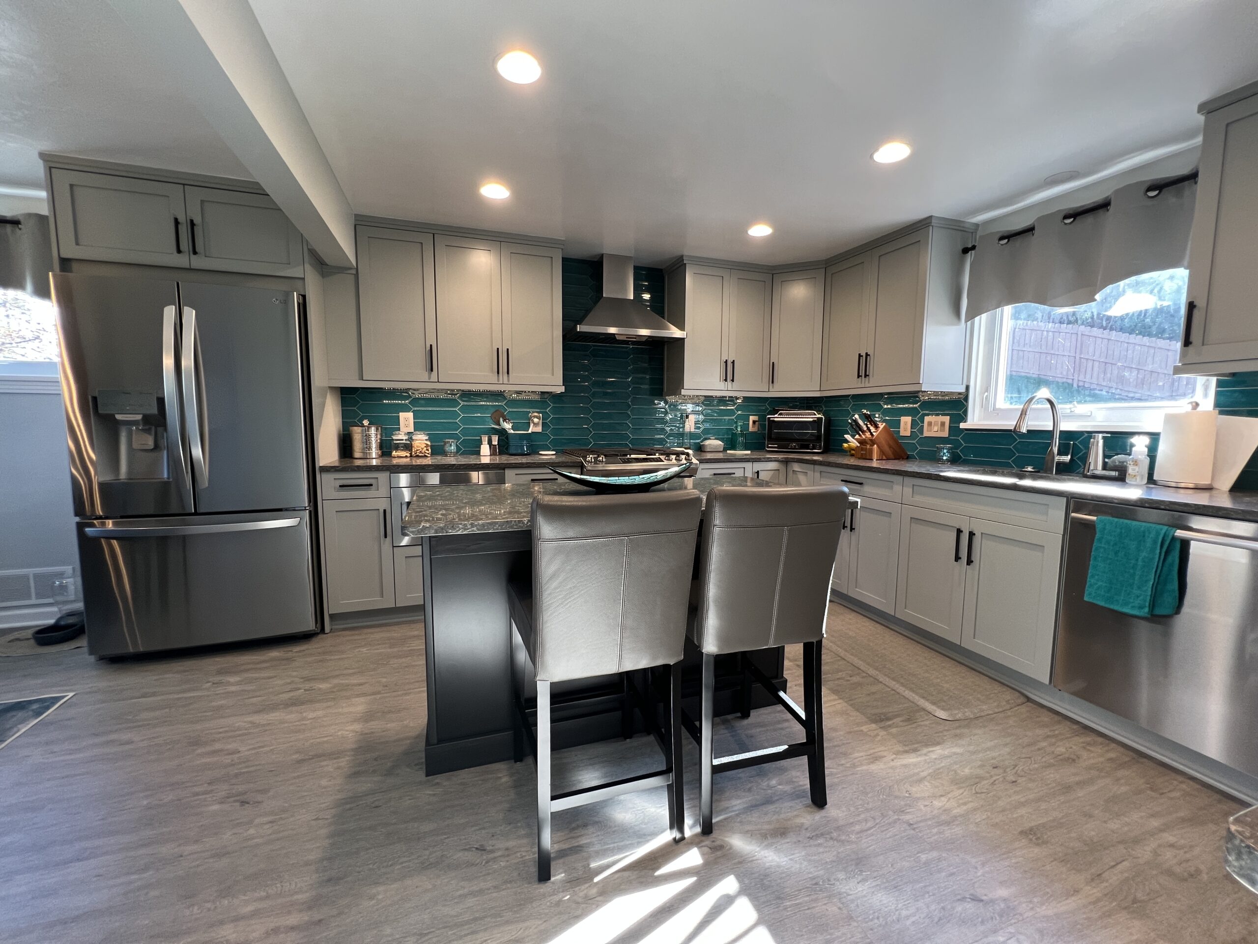 Classic full kitchen remodel, blue teal tiles, little grey marble island, storage cabinets, spacious counter