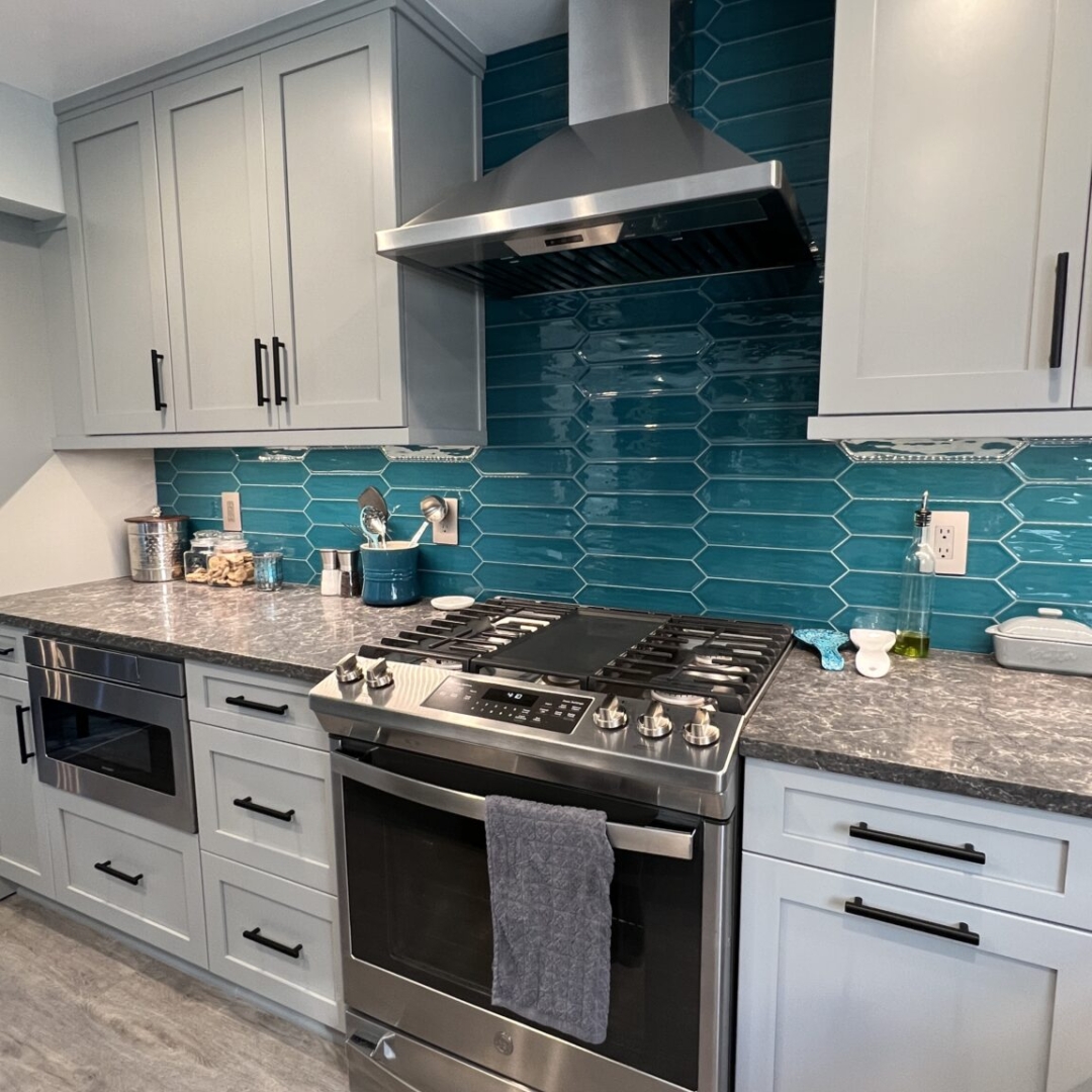 Classic full kitchen remodel, blue teal tiles, grey stove, little grey marble island, storage cabinets, spacious counter