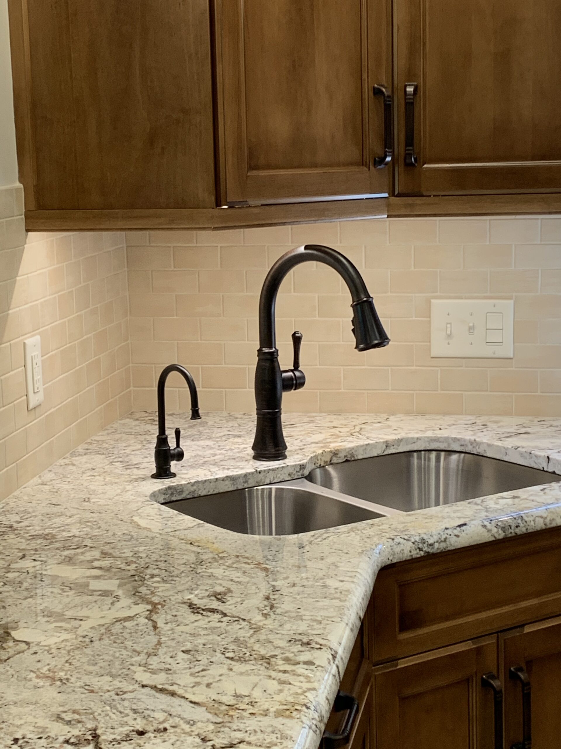 Traditional black kitchen faucet, two separate sinks, marble counter