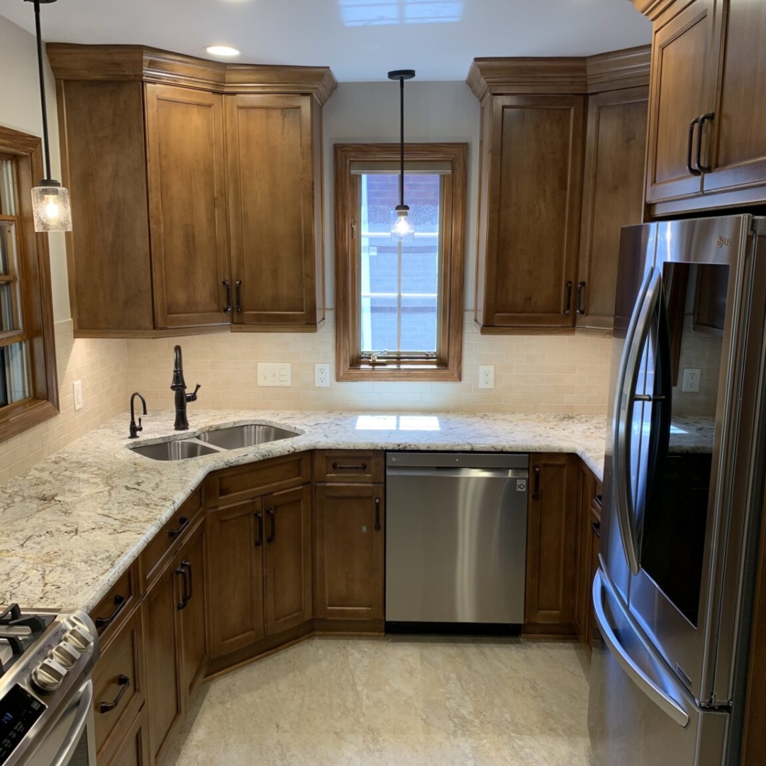 Traditional small kitchen remodel, marble counter, brown cabinets, black kitchen faucet, window