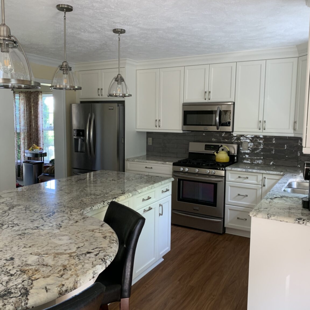 Classic white kitchen remodeling, big island with marble countertop, white cabinet storage, marble counter