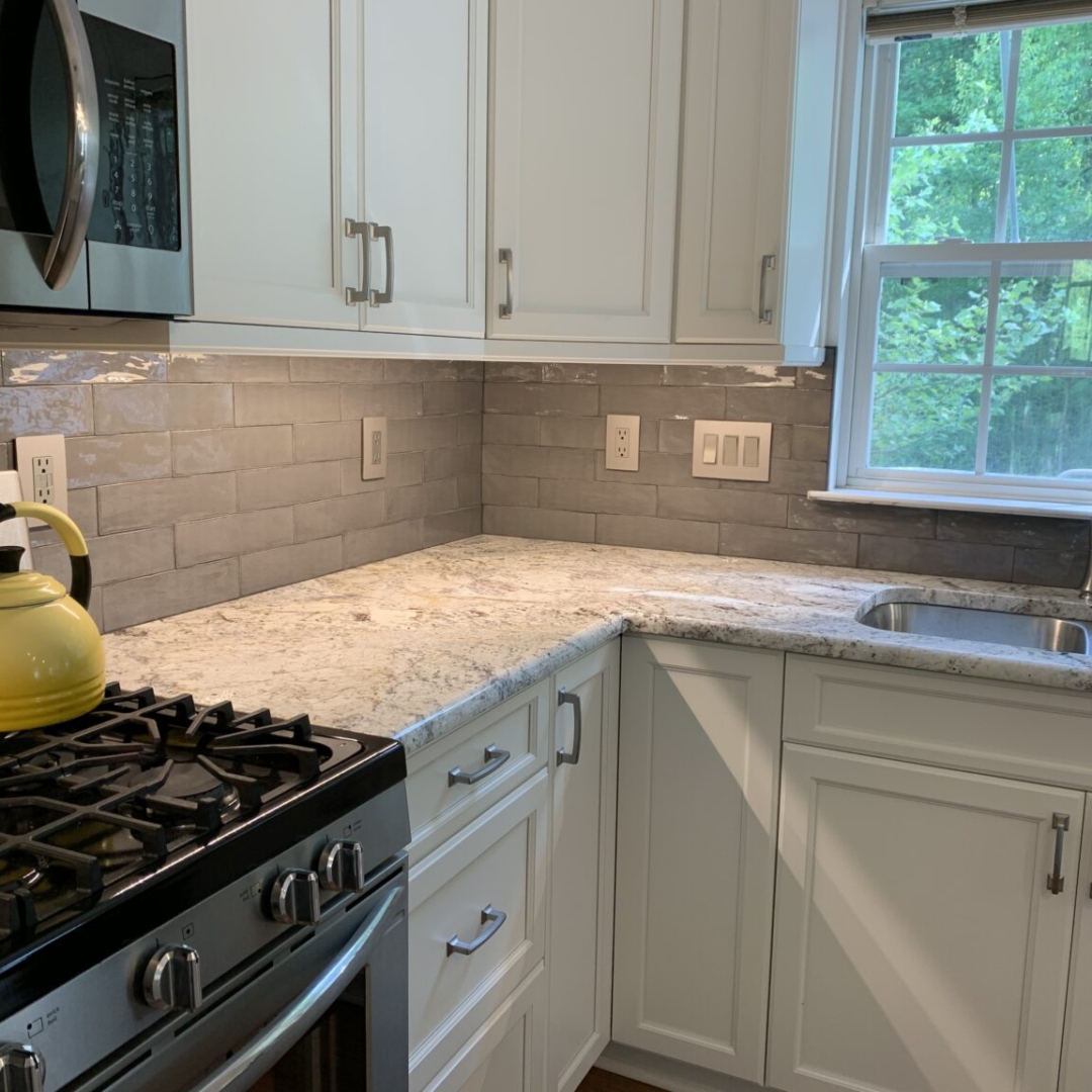 Classic white kitchen remodeling, marble counter, grey tile backsplash, white closet storage