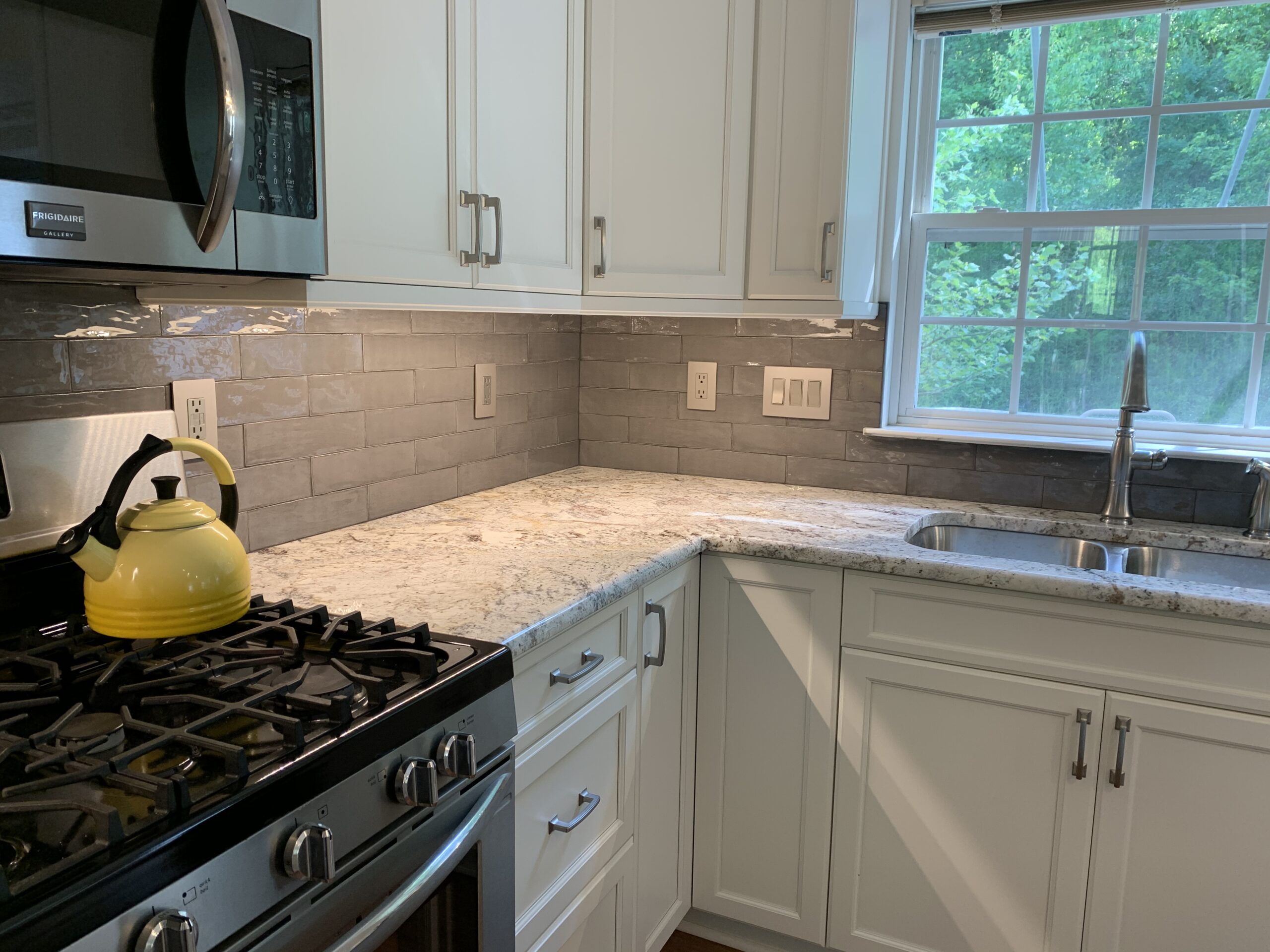 Classic white kitchen remodeling, marble counter, grey tile backsplash, white closet storage