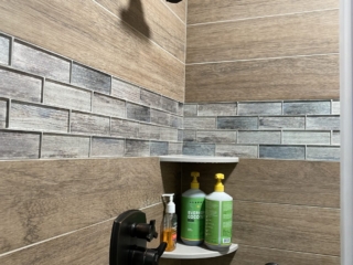 Contemporary bathroom, wood tile shower, classic white shelves, black shower head