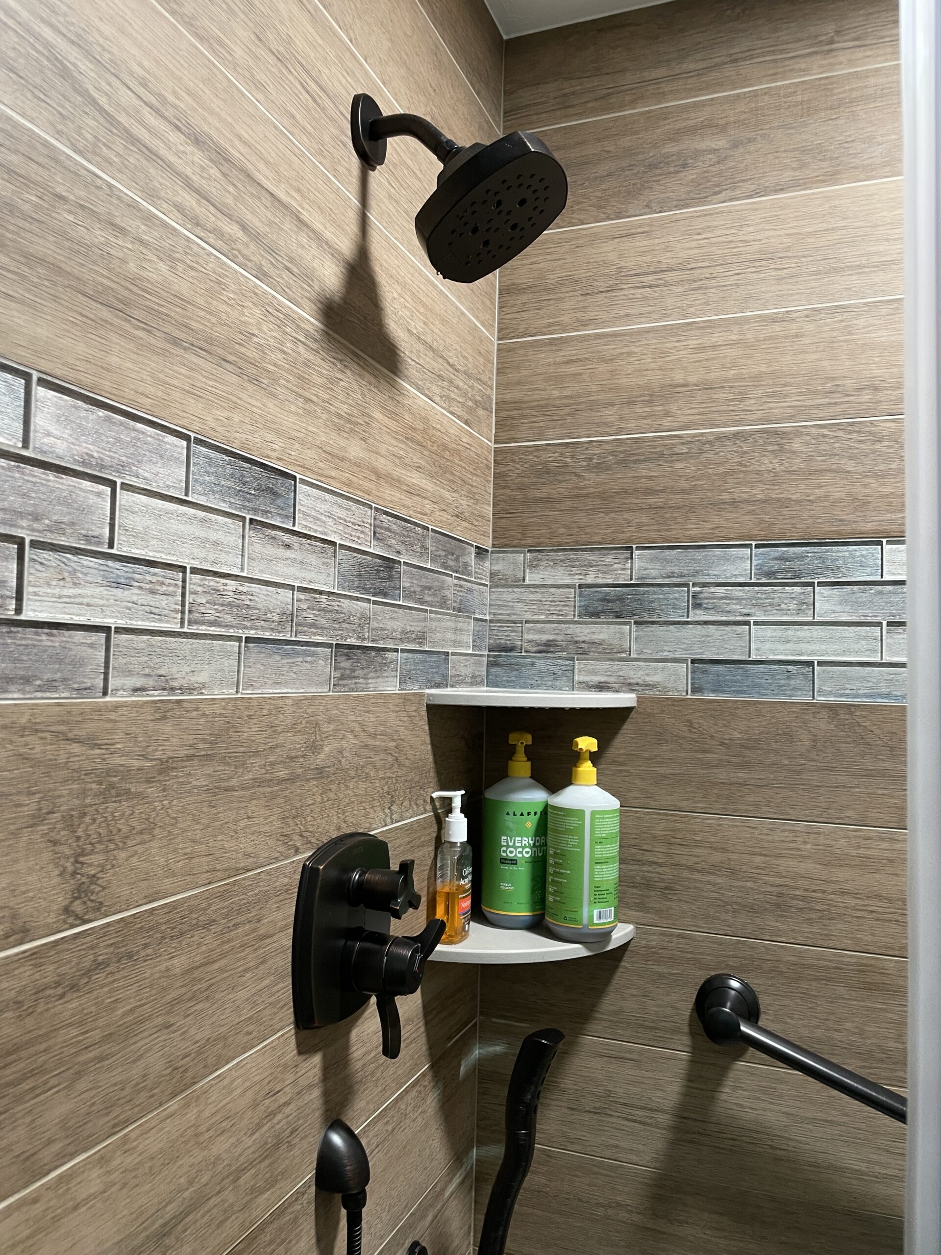 Contemporary bathroom, wood tile shower, classic white shelves, black shower head