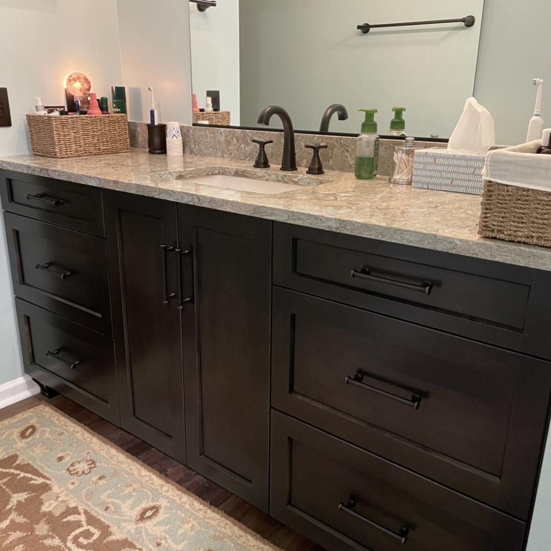 Classic bathroom remodel, marble countertop sink, dark cabinet storage
