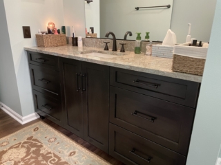 Classic bathroom remodel, marble countertop sink, dark cabinet storage