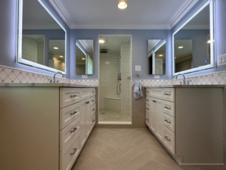 Classic bathroom remodel with a shower, two separate sinks and storage, modern brown floor