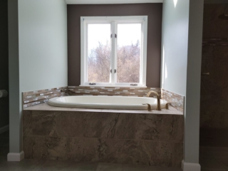 Luxury soaking tub idea, brushed gold fixtures, natural light, elegant bathroom retreat
