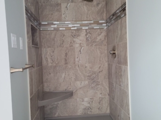 Walk-in shower inspiration, gold rain shower idea, modern spa bathroom, neutral-tone shower design, warm-tone tile shower, showered inspiration