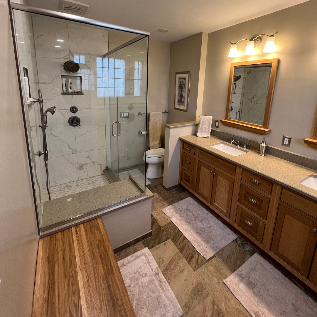 Classic bathroom remodel with two sinks and brown wooden cabinet storage, shower, modern floor tiles