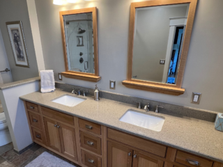 Bathroom remodel with a large 2 sink and wooden storage with modern floor tiles