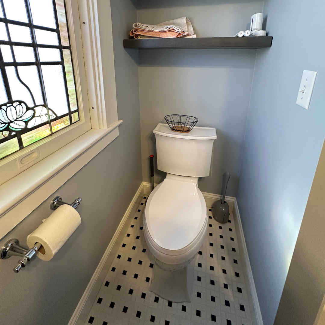 Traditional small bathroom remodel with classic two-piece toilet, Black and white squared floor tiles, window