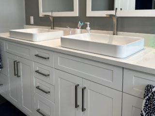 Contemporary white double sink with individual basins, white marble countertop, white cabinet storage