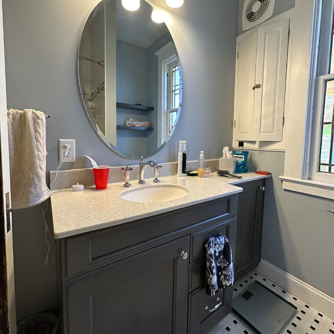 Traditional small bathroom remodel with small modern single sink, marble countertop sink, dark cabinets
