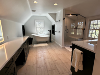 Contemporary spacious bathroom remodel, bath tub and shower, white double sink, modern brown floor