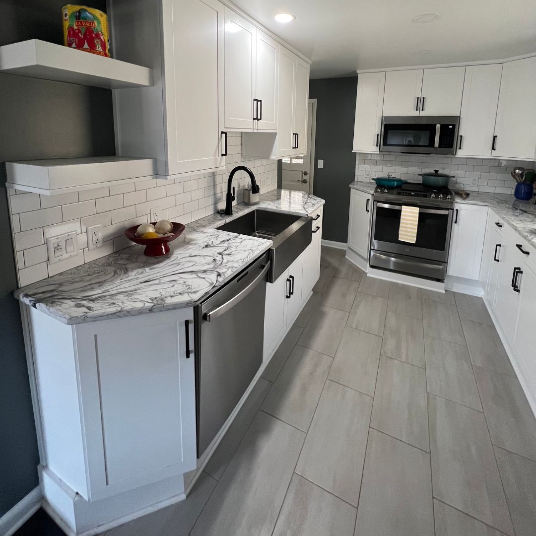 Contemporary kitchen remodel, marble countertop, large white cabinets for storage, modern grey floor tiles