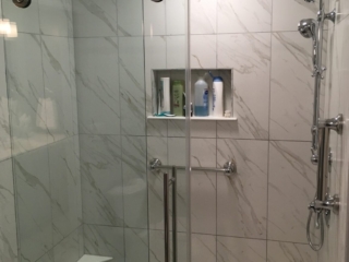 Classic bathroom, shower, small shelves, black and white marble tile walls