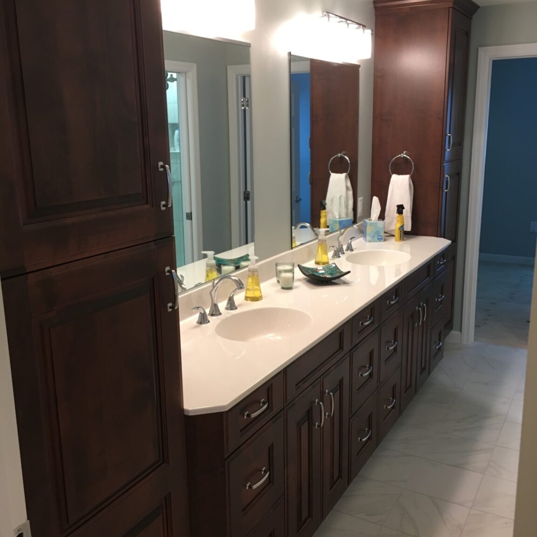 Classic bathroom, brown double sink, white marble countertop, large cabinet storage