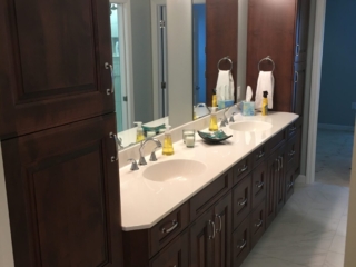 Classic bathroom, brown double sink, white marble countertop, large cabinet storage