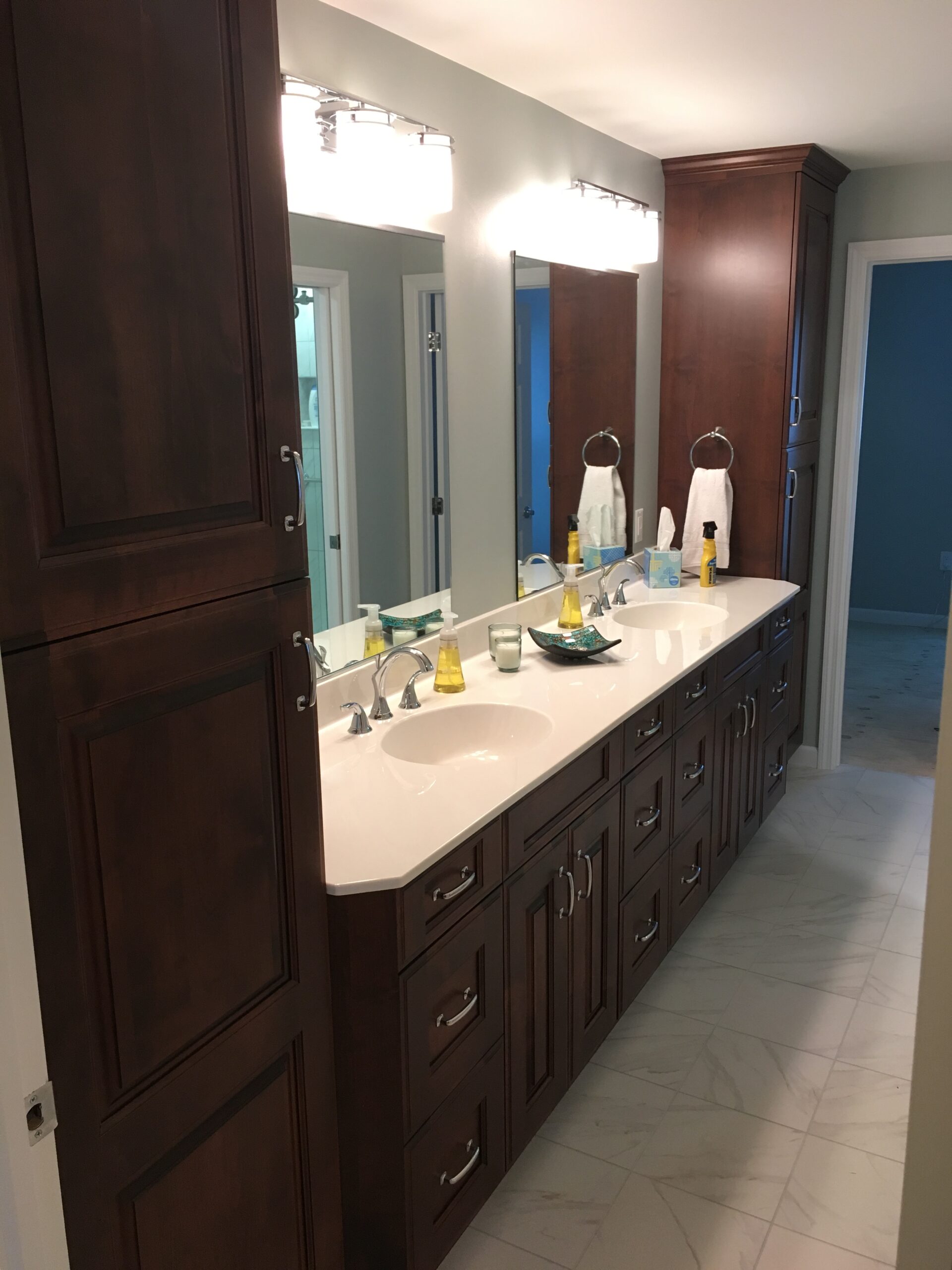 Classic bathroom, brown double sink, white marble countertop, large cabinet storage