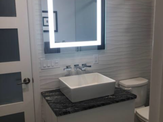 Contemporary bathroom, modern small sink, black marble, one-piece toilet