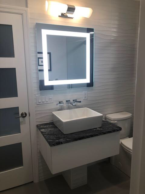 Contemporary bathroom, modern small sink, black marble, one-piece toilet