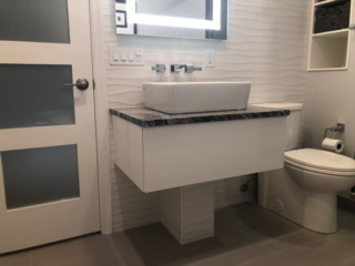 Contemporary bathroom, modern small sink, black marble, one-piece toilet