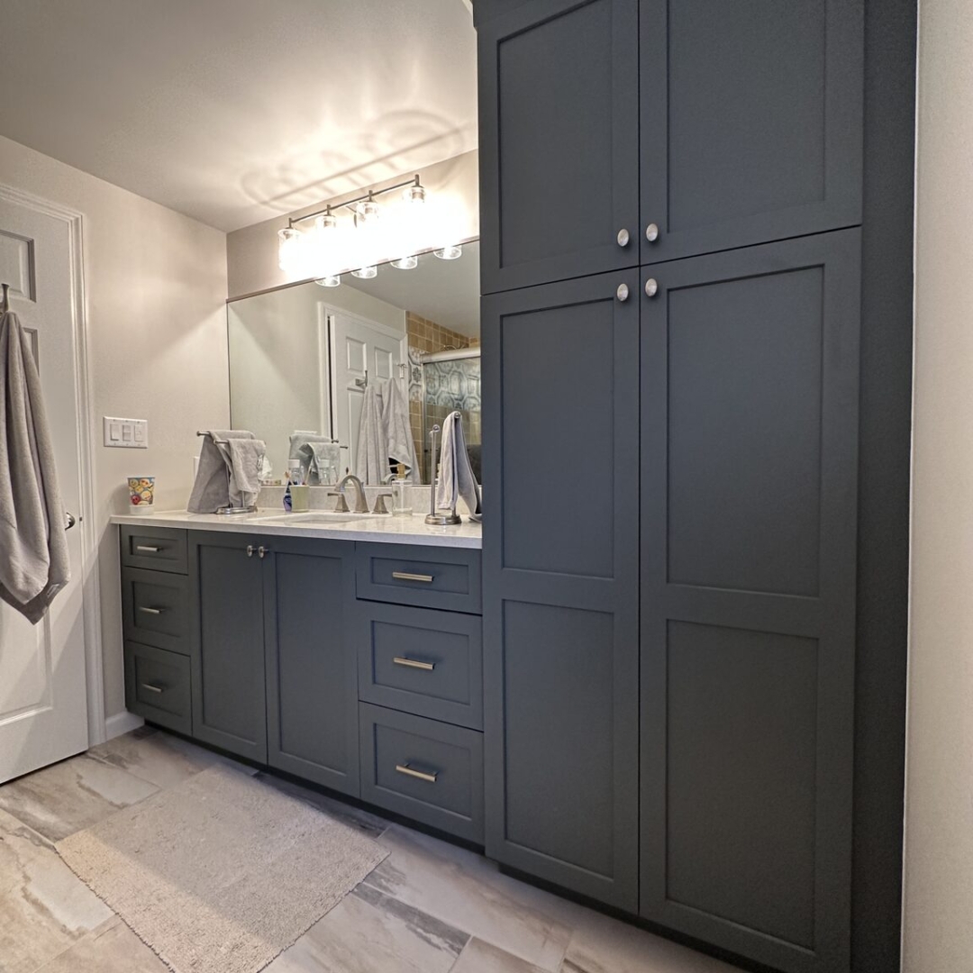 Matte dark grey cabinets, floor-to-ceiling bathroom storage, marble-look porcelain floor tiles, modern design