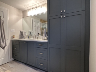 Matte dark grey cabinets, floor-to-ceiling bathroom storage, marble-look porcelain floor tiles, modern design