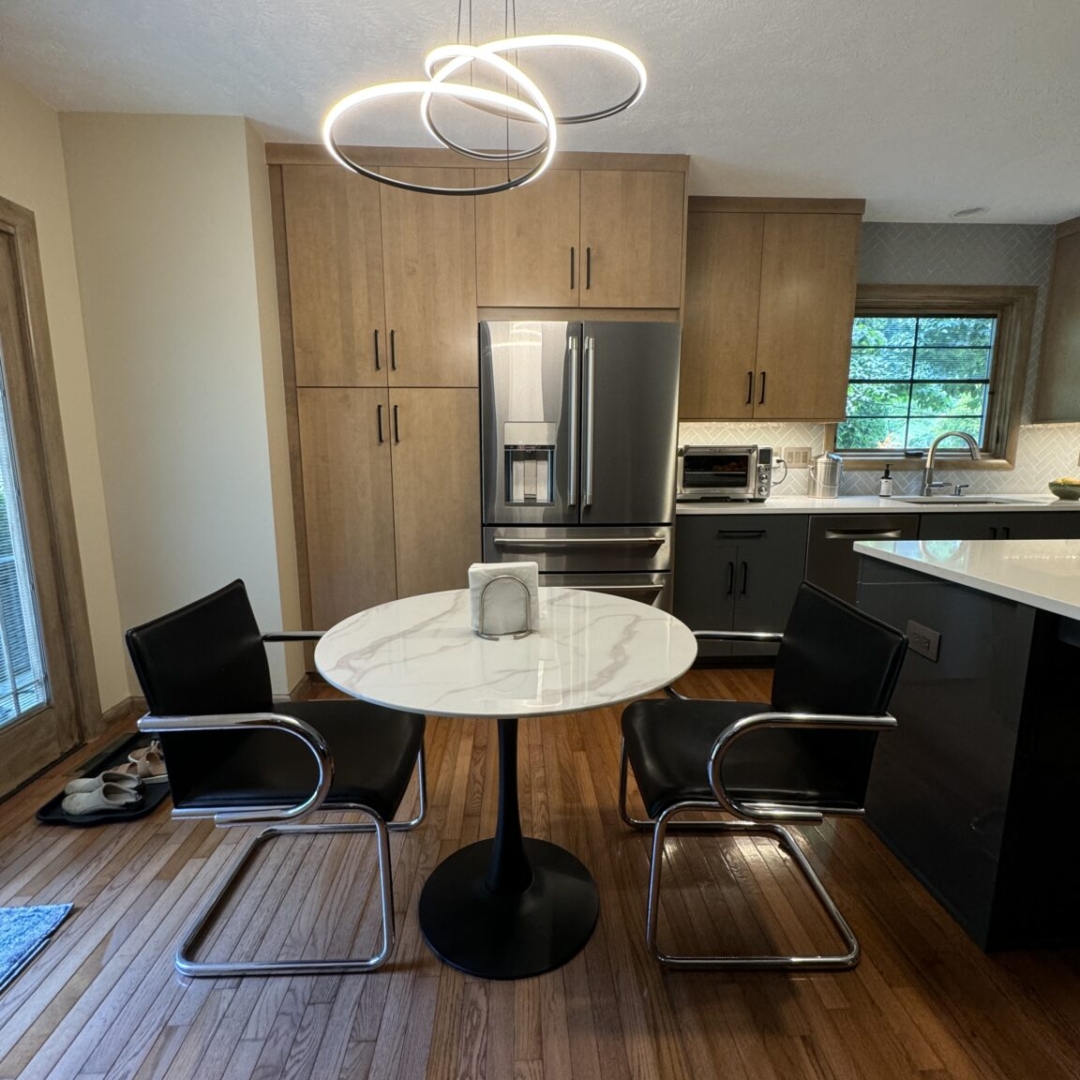 Modern kitchen nook idea, sleek back chairs, contemporary LED pendant lighting, functional design