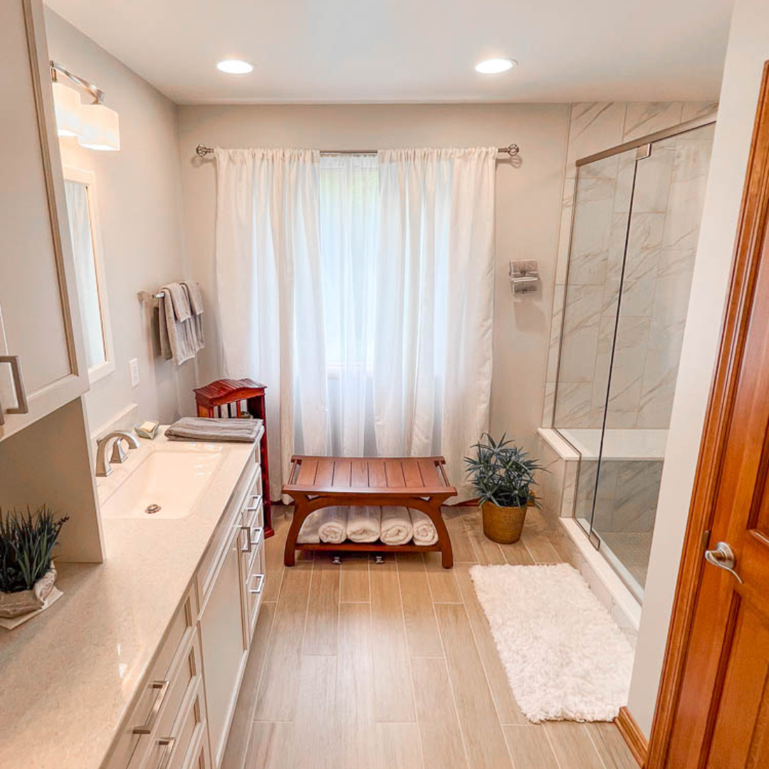 Classic bathroom, large cabinet storage, marble shower, light brown modern floor tiles, big window