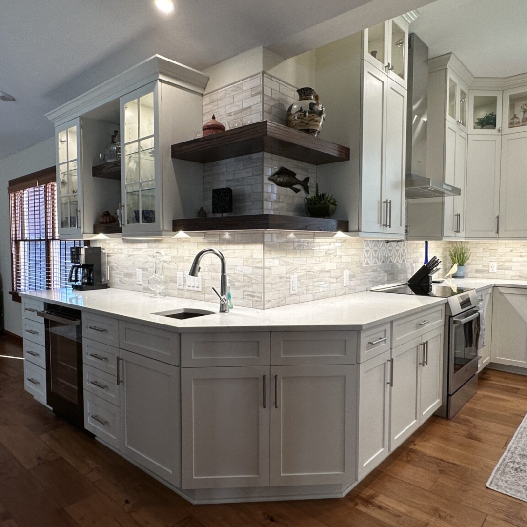 Classic white kitchen counter and stove, white marble countertop, white wall and base cabinets, farming sink, modern white tile backsplash, brown tile floor