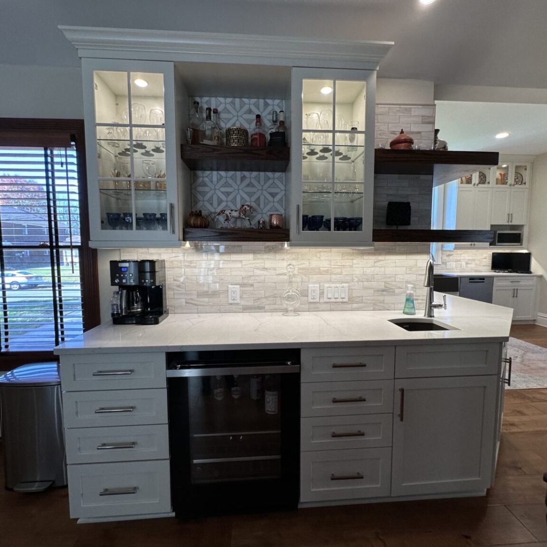 Classic white kitchen, white marble countertop, white wall glass cabinet, white base cabinets and drawers, sink, modern white tile backsplash, brown tile floor