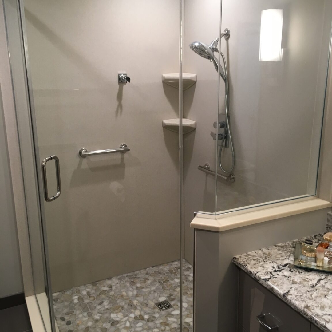 Frameless glass shower door, pebble stone shower floor, glass enclosure, contemporary bathroom, walk-in shower, built-in shelves