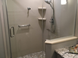 Frameless glass shower door, pebble stone shower floor, glass enclosure, contemporary bathroom, walk-in shower, built-in shelves