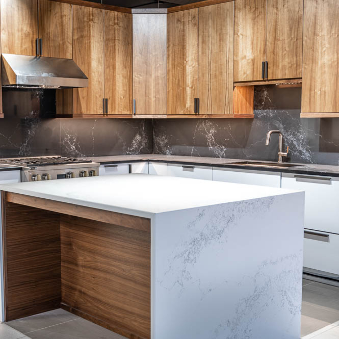 Contemporary kitchen, white marble island, black marble backsplash, brown wall cabinets, white base cabinets, black marble countertop, grey rectangle floor tiles, counter lighting