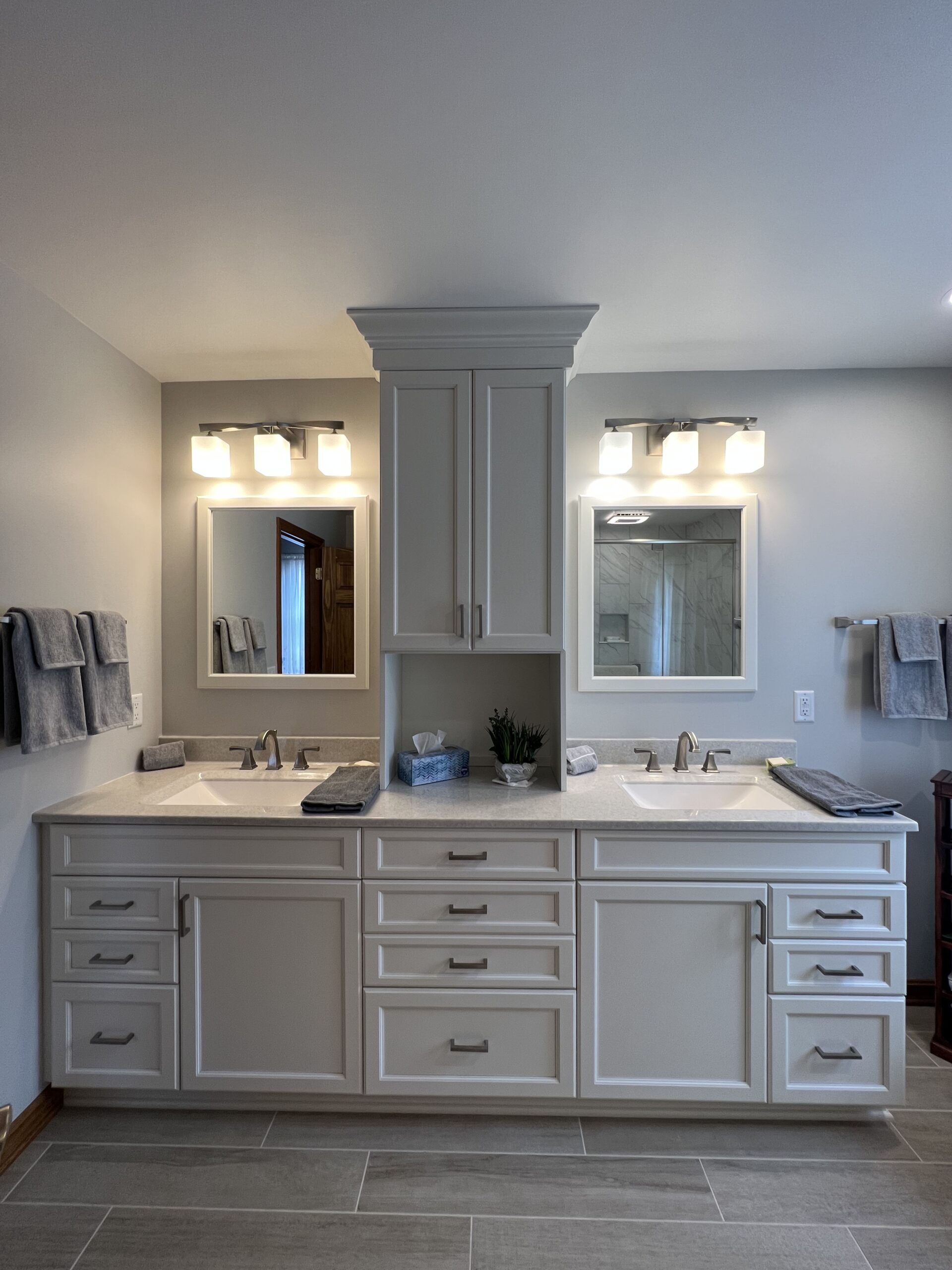 Modern bathroom, separated double sink, white marble countertop sink, large white cabinet storage, two mirrors