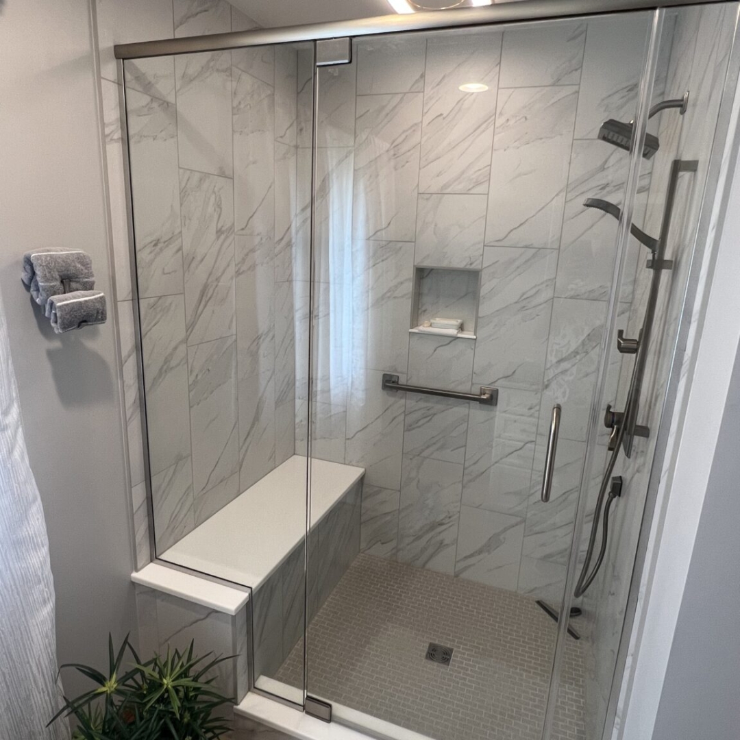 Modern bathroom, white marble tile shower walls, grey floor shower tiles, shower seat