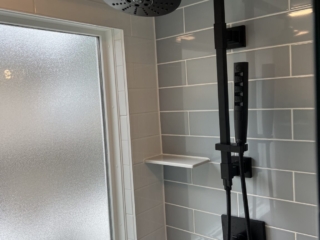 Matte black shower head, rainfall shower idea, sleek shower design, shower shelf ideas